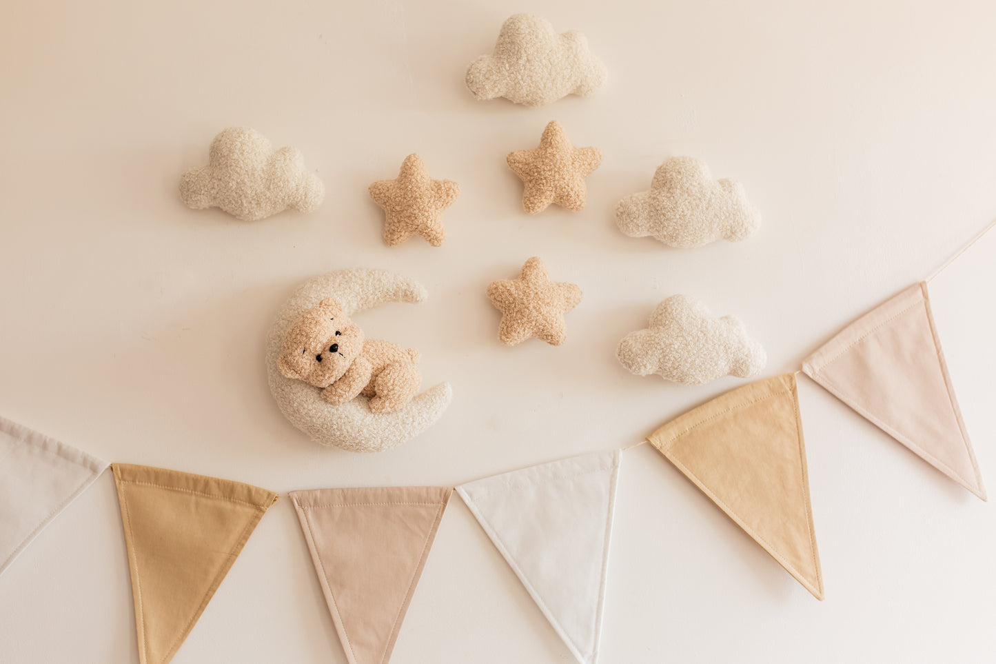 Decorative setup with teddy bears and bunting on a light background