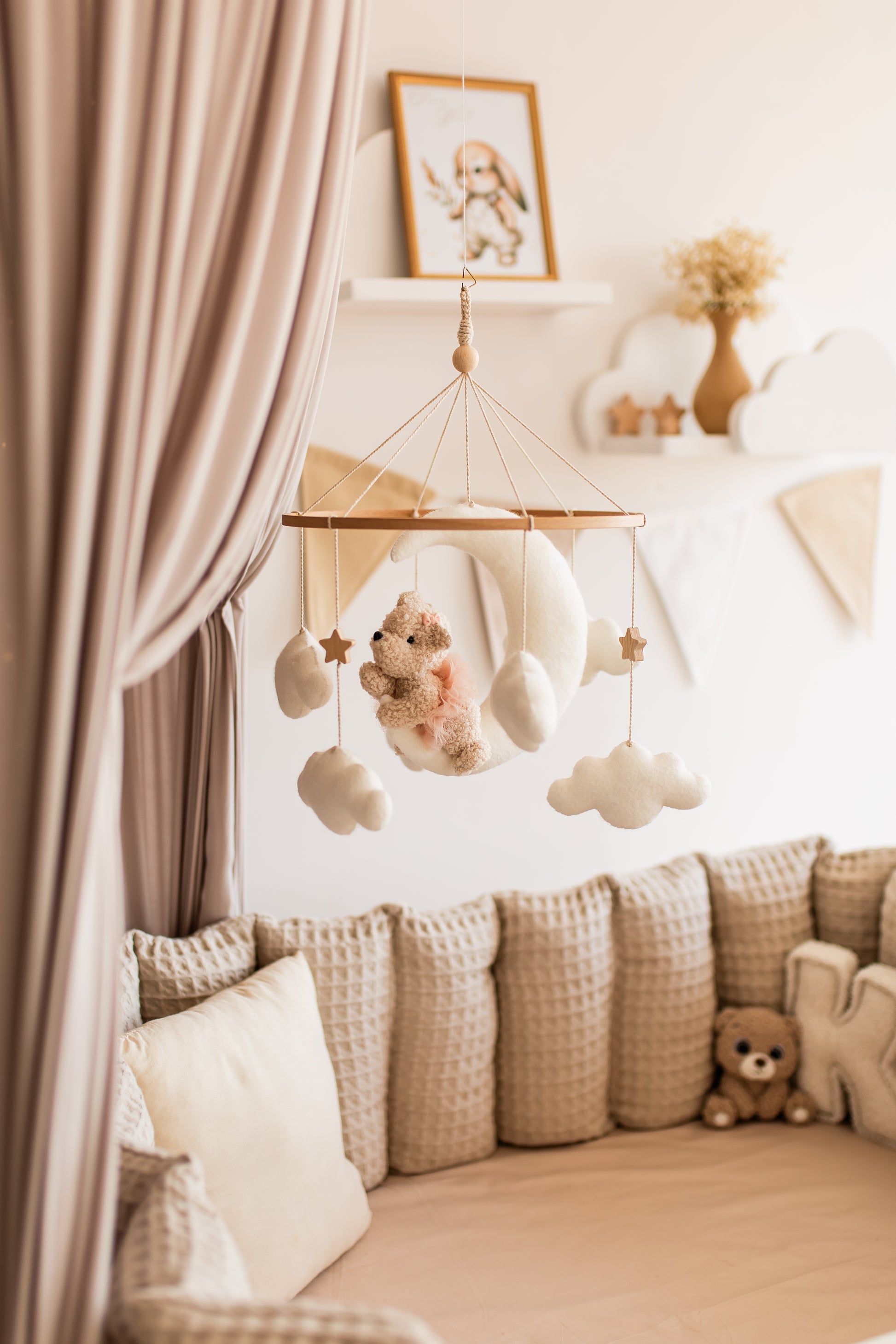 Children's room with a crib, baby bear mobile, and decorative items.