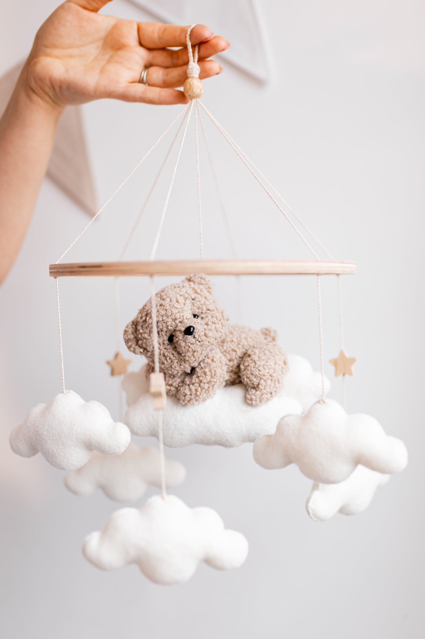 Baby mobile with teddy bear and clouds on a white background
