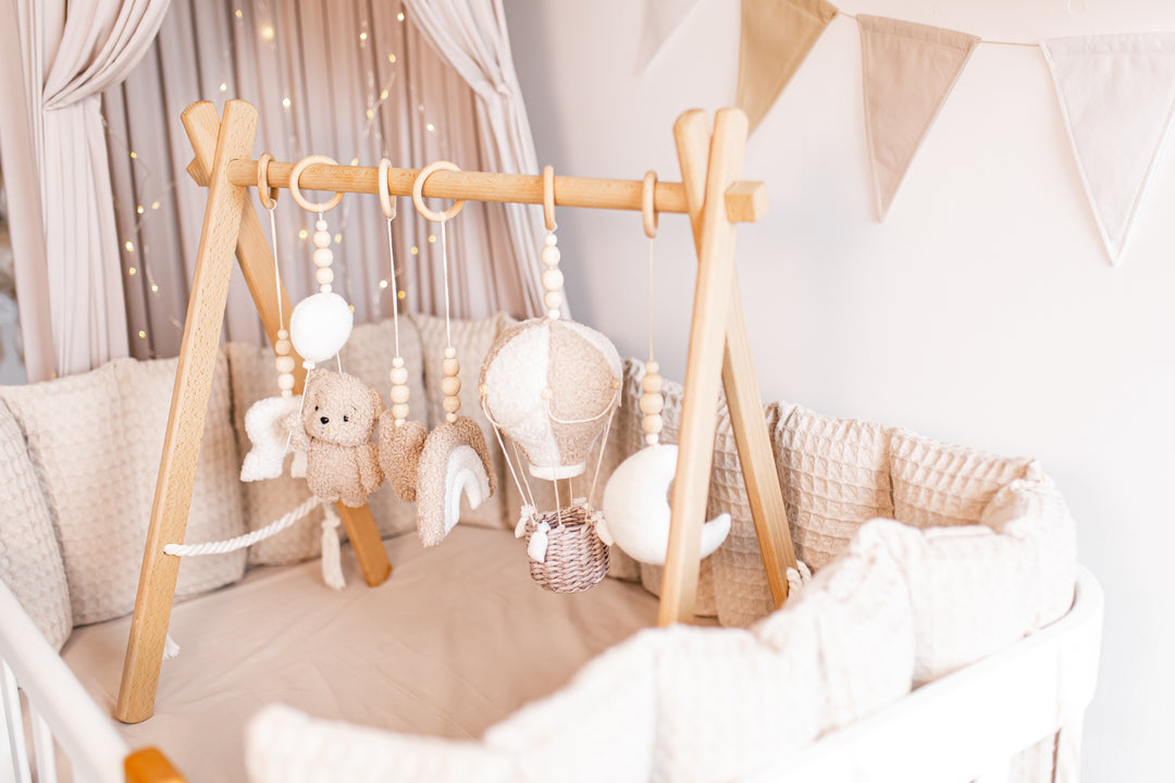 Baby play gym with hanging toys in a nursery setting