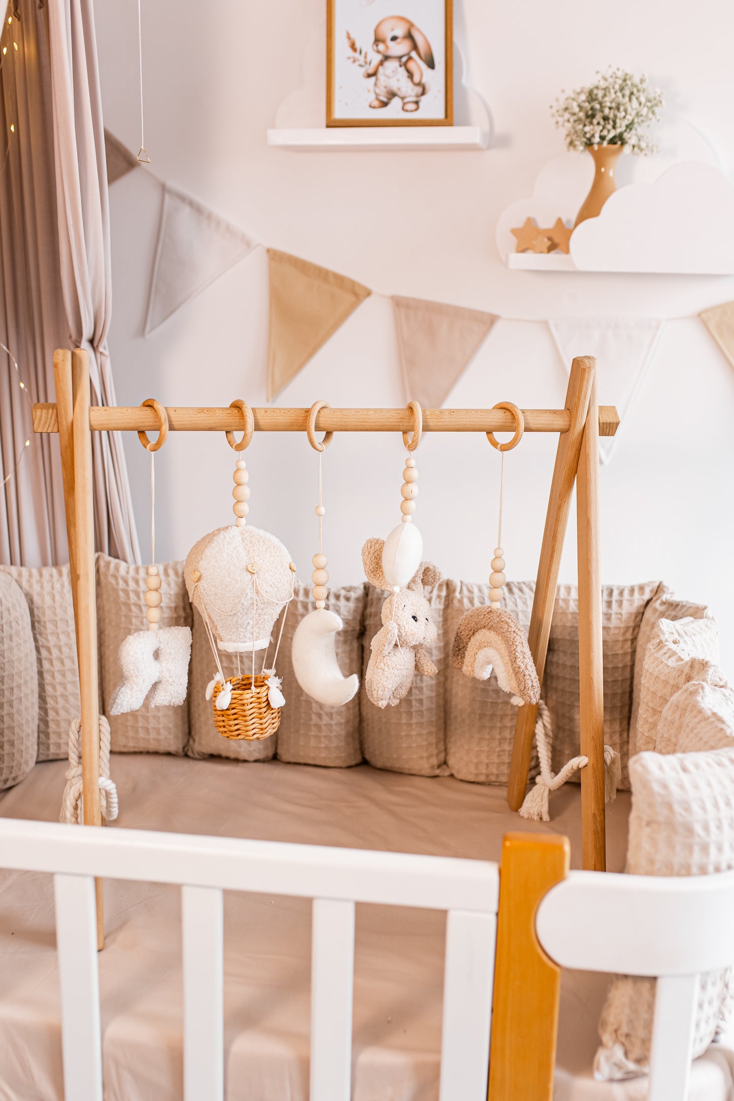 Wooden crib with hanging toys baby gym in a baby's room