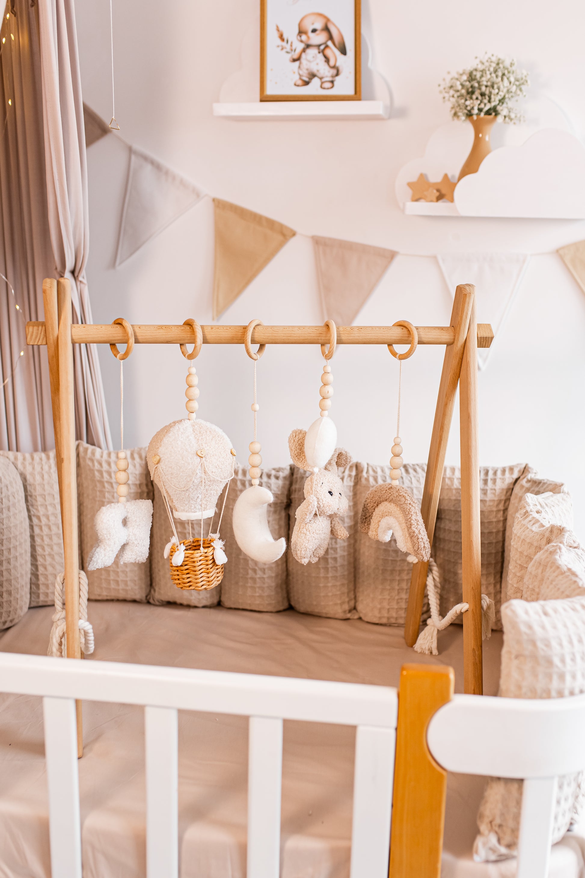 Wooden crib with hanging toys baby gym in a baby's room