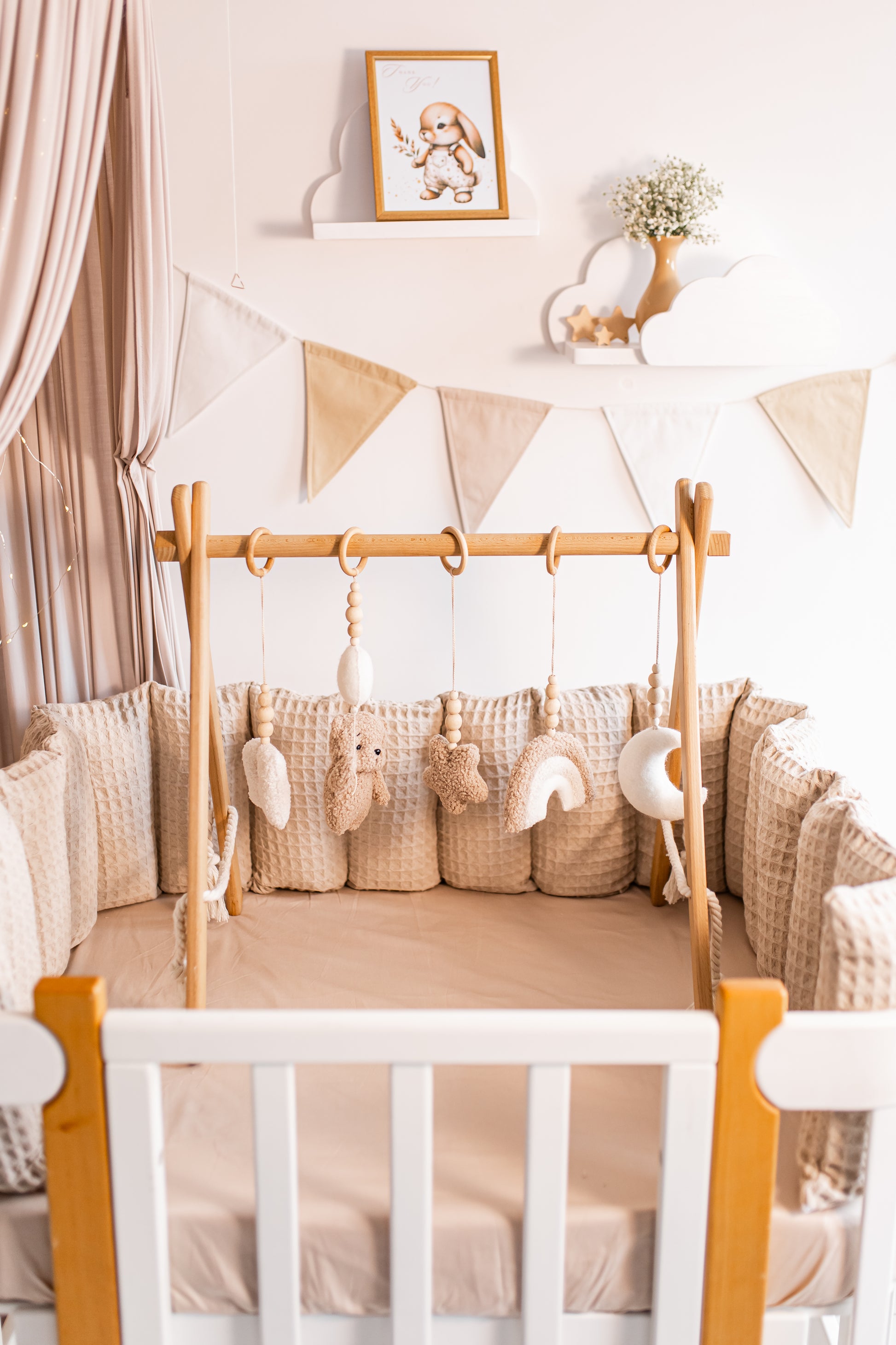 Nursery room with crib, decorative flags, and baby gym.