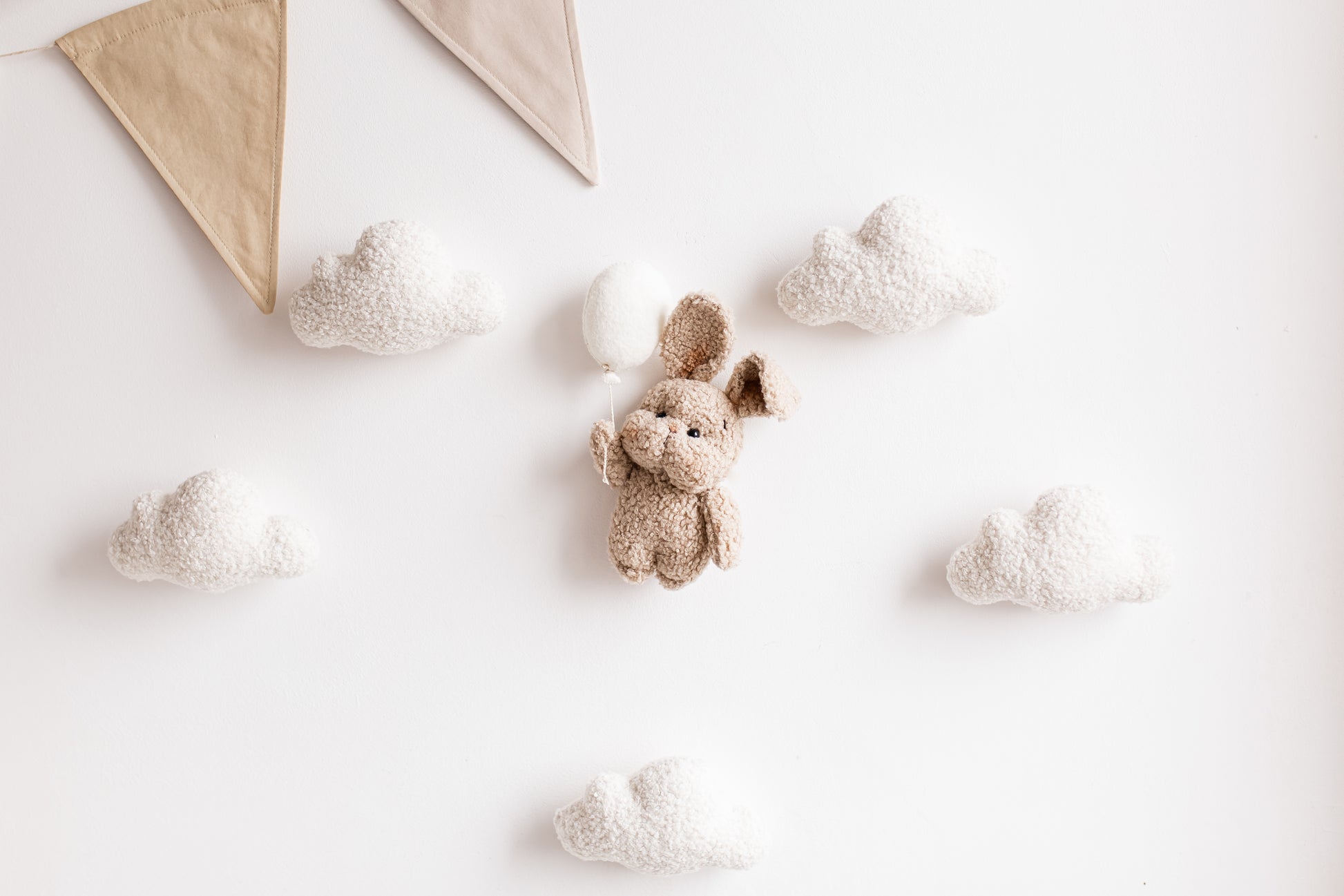 Cozy bunny with balloon wall décor for nursery
