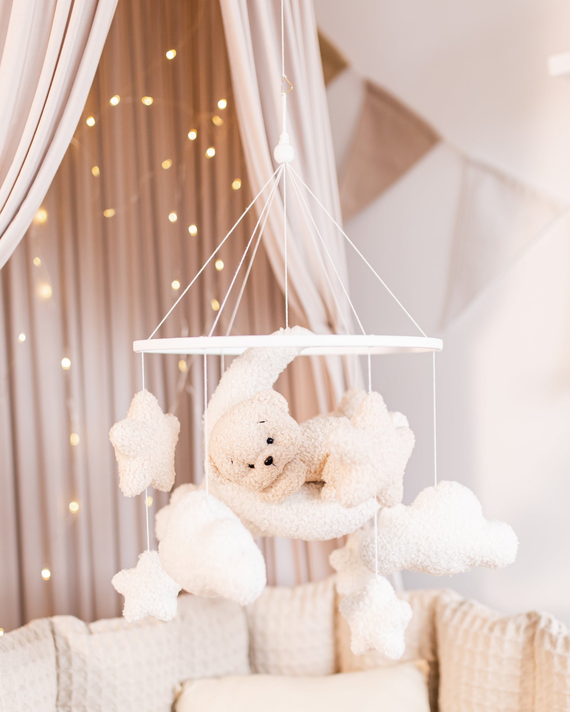 Boucle crescent moon baby mobile with stars and clouds hanging above crib
