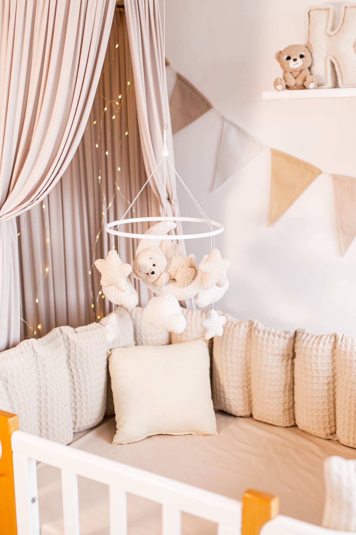 Children's room with crib, teddy bears baby mobile, and decorative elements.