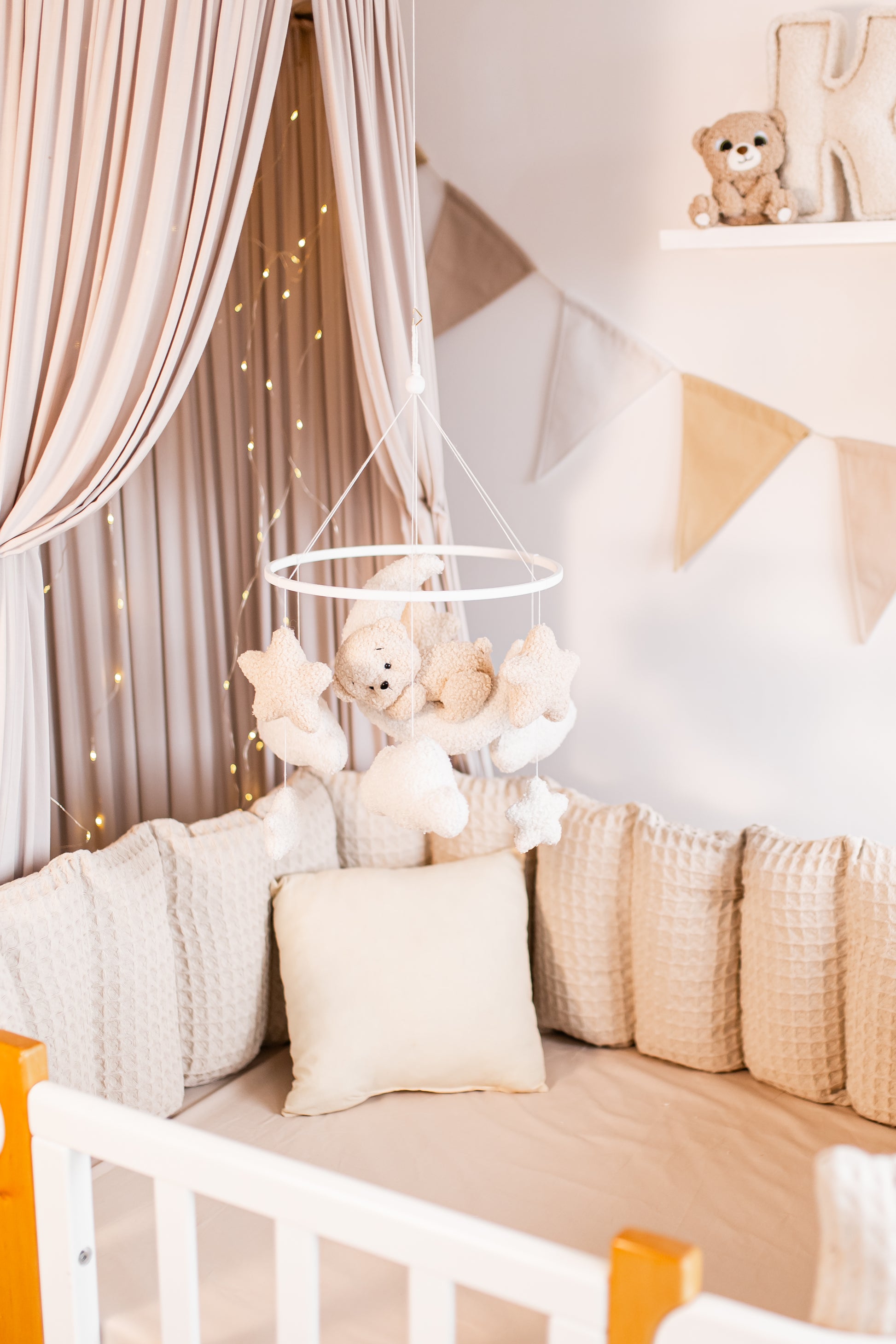 Children's room with crib, teddy bears baby mobile, and decorative elements.