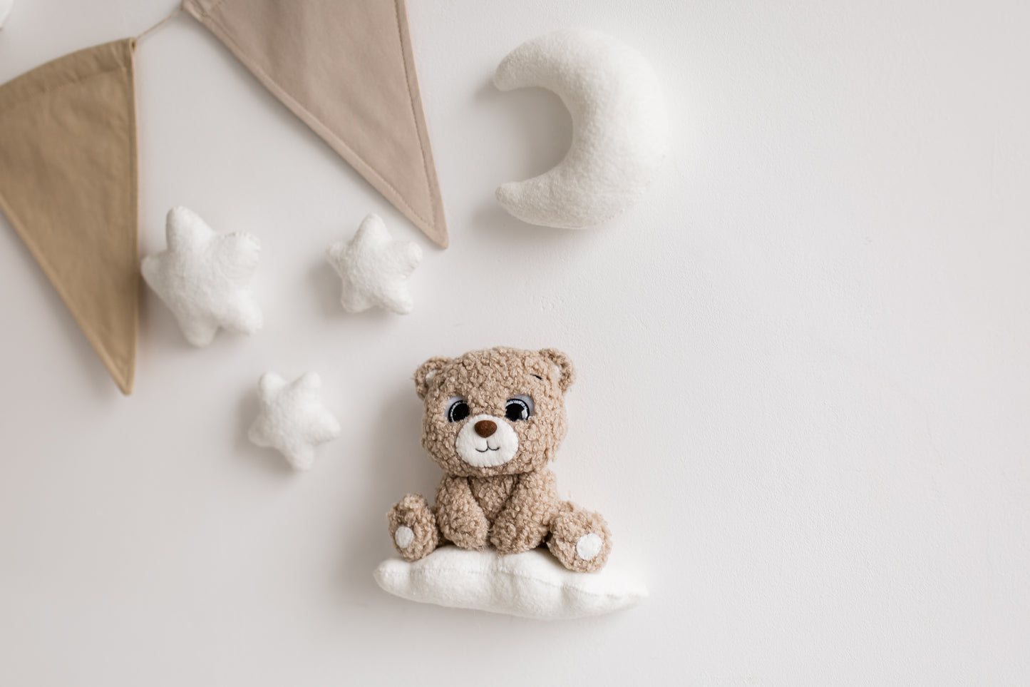 Whimsical bouclé bear wall décor with soft lighting—perfect for nursery design