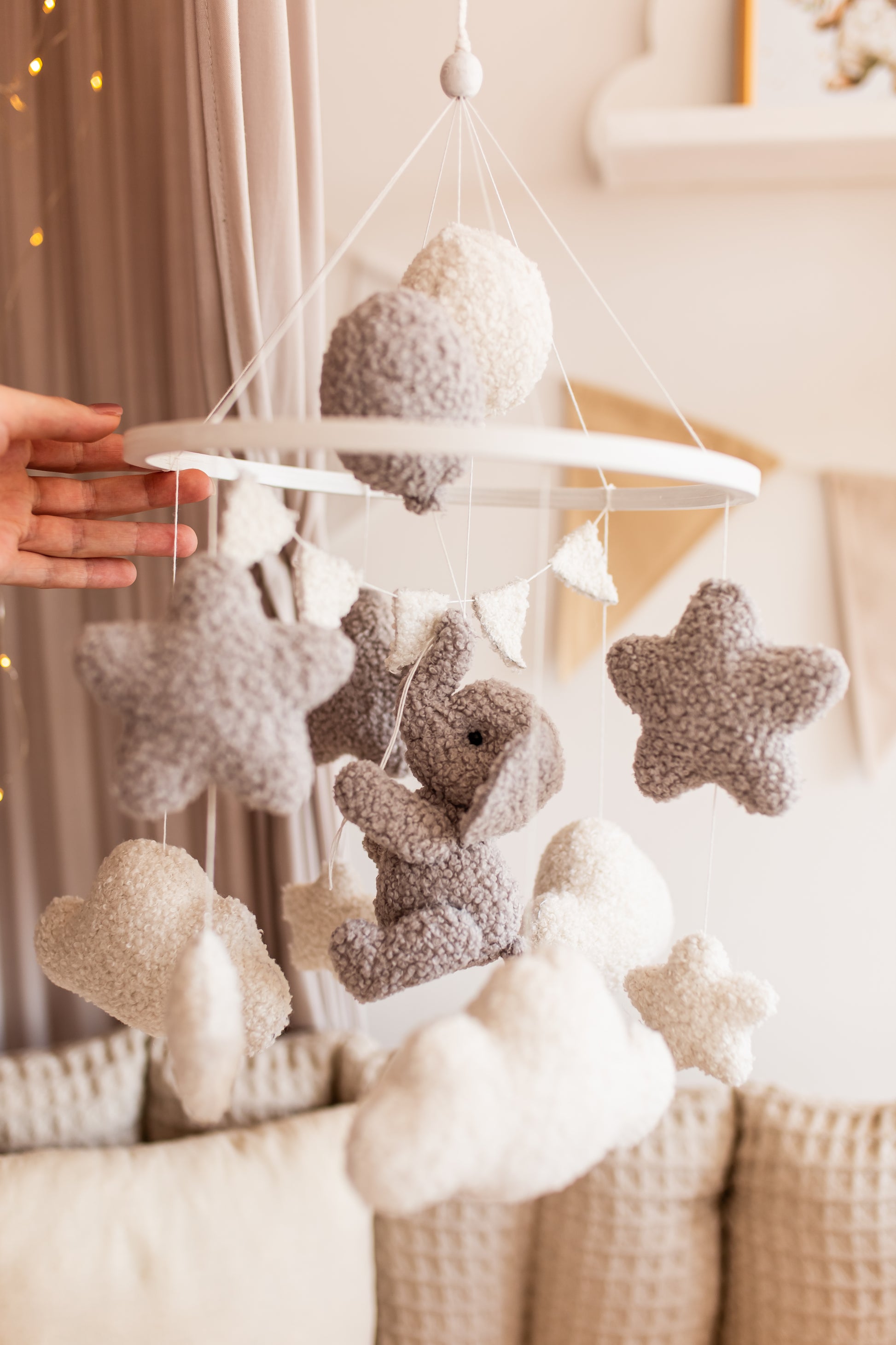 Baby mobile with stars and bunnies hanging from a crib