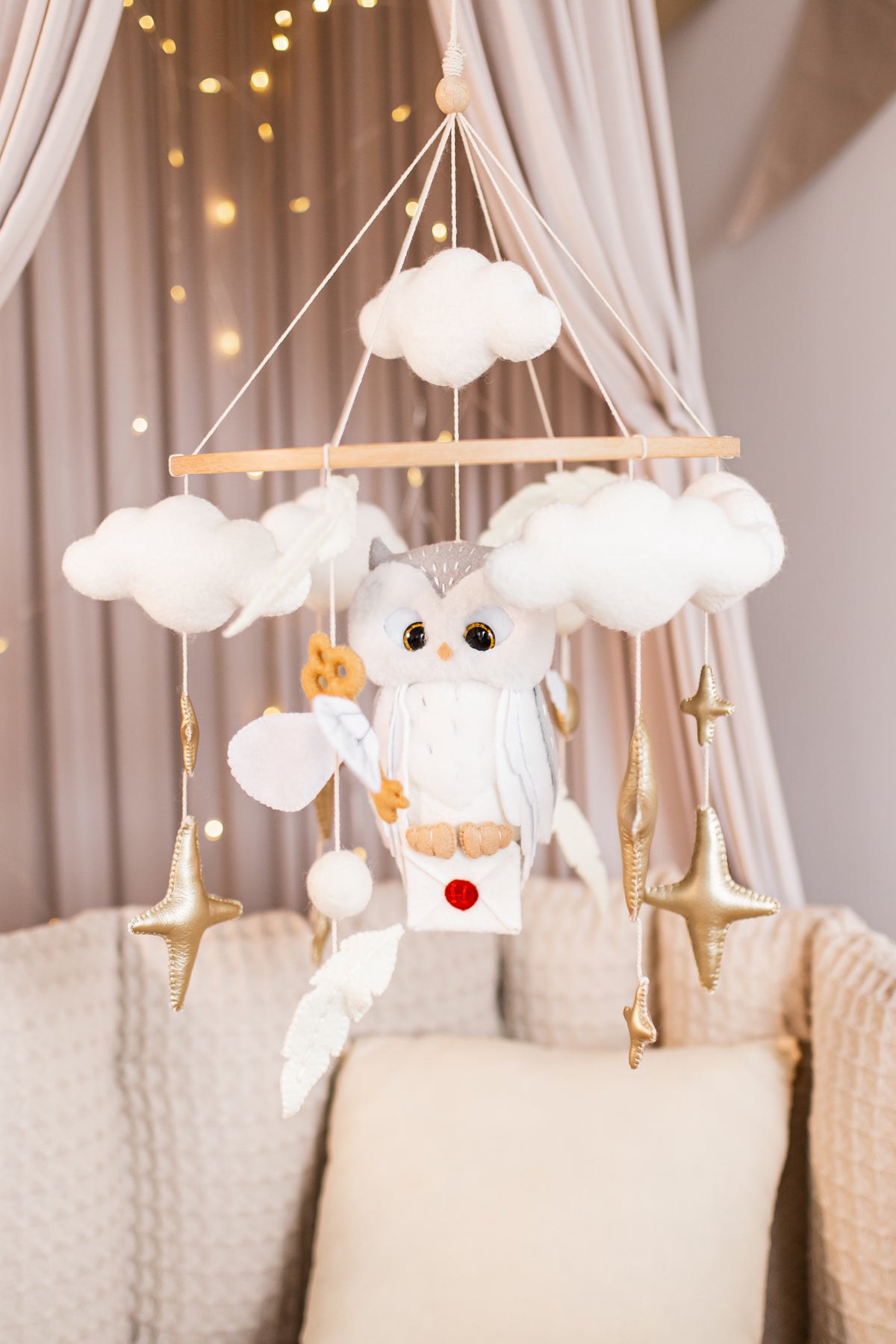 Handmade boucle owl wizard mobile hanging above crib