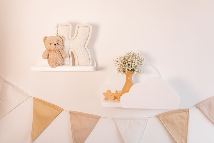 Decorative setup with a teddy bear, letter &