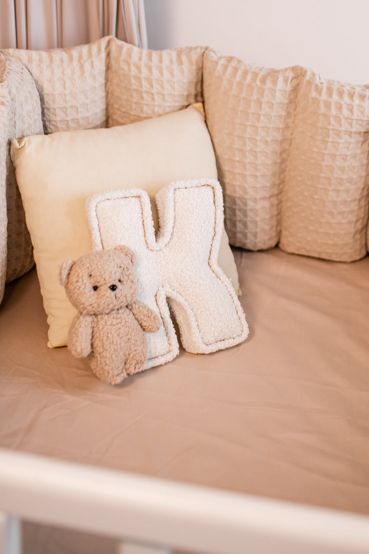 Beige teddy bear and letter &