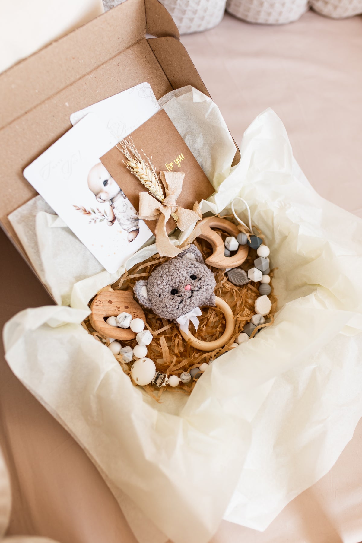 Handmade boucle kitten rattle toy in neutral nursery tones
