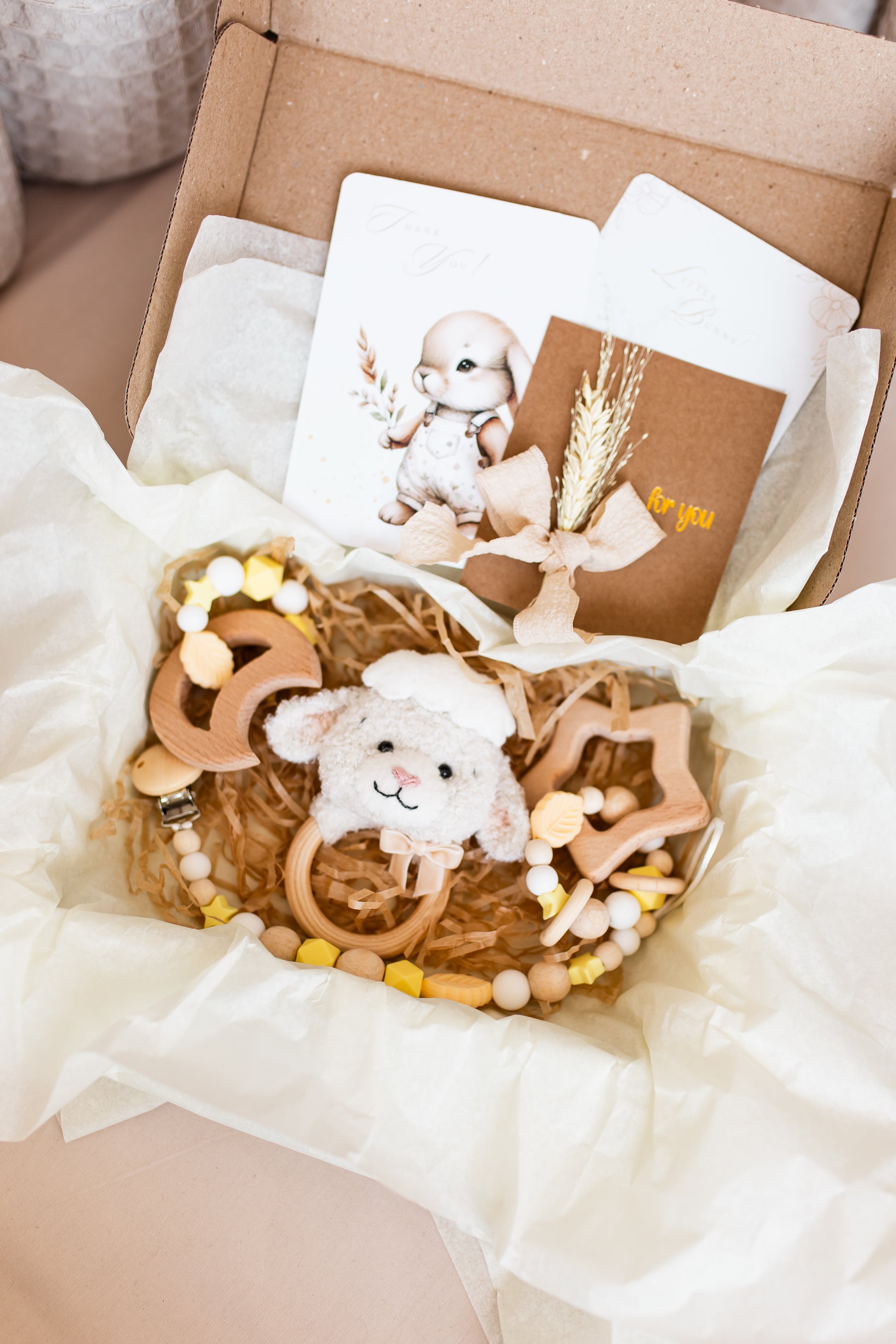 Baby gift set with wooden toys and a card in a box
