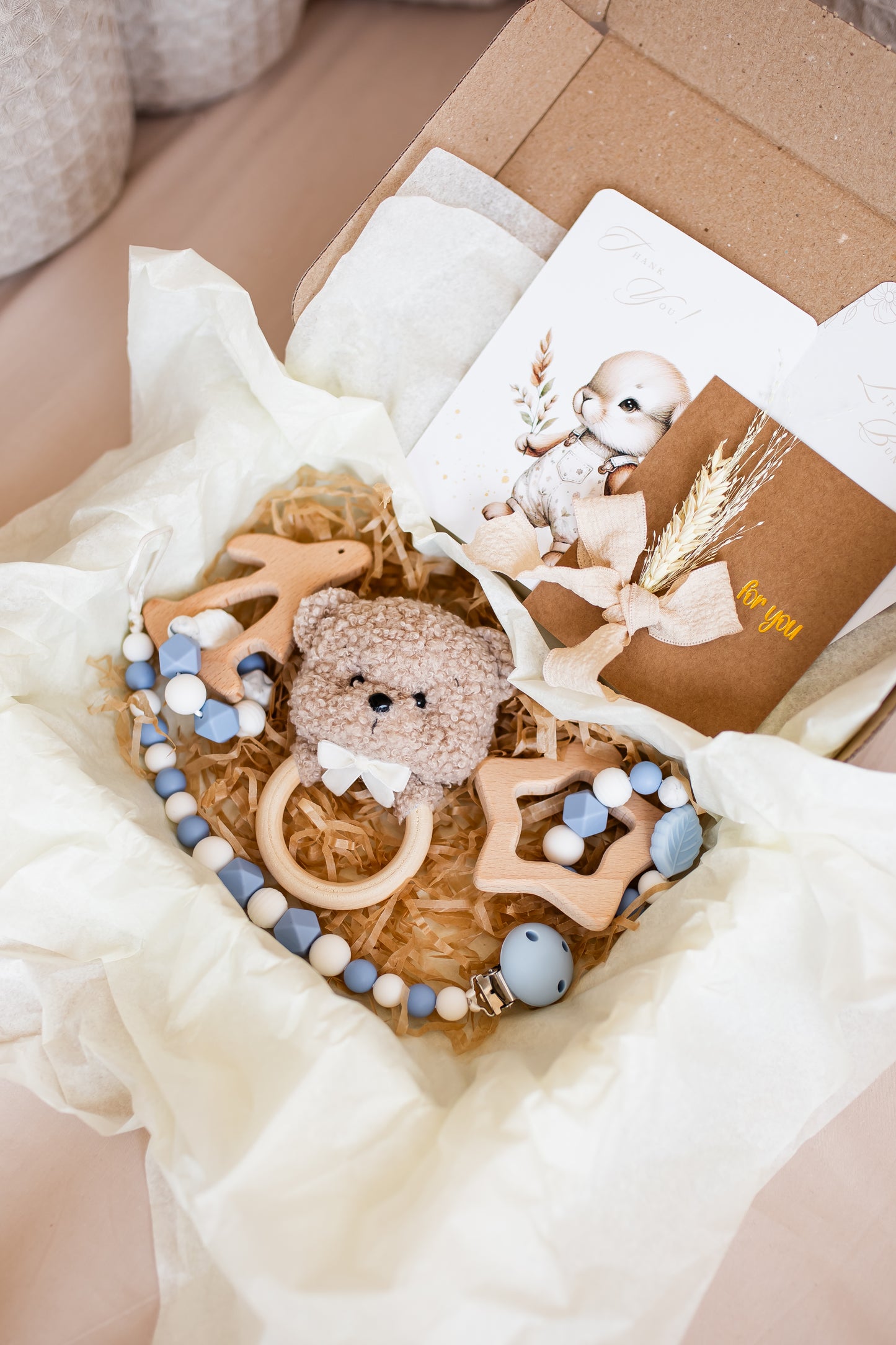 Baby teething ring with teddy bear and beads in a box
