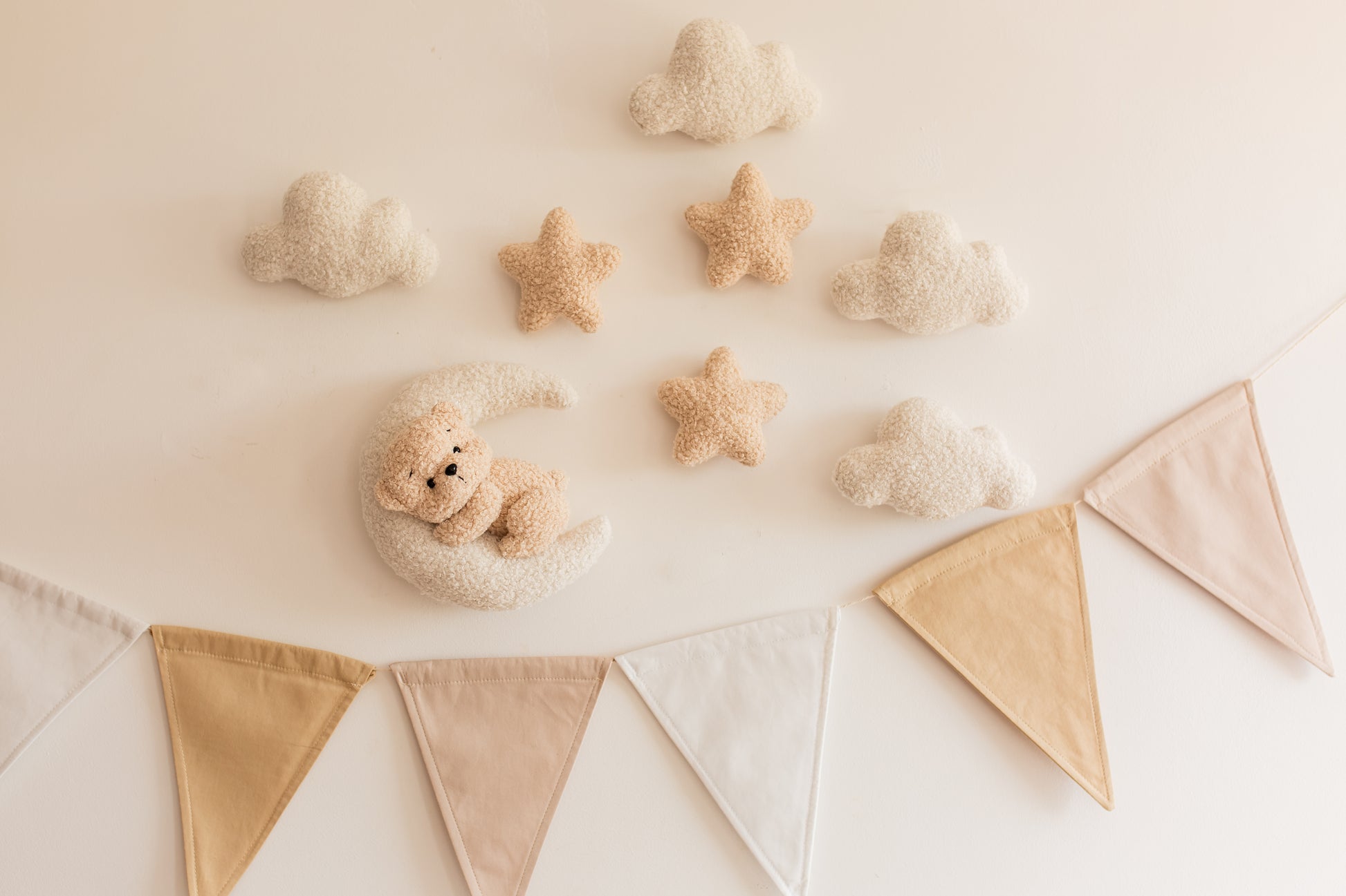 Decorative setup with teddy bears and bunting on a light background